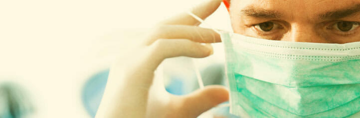 Hospital doctor taking off surgical mask